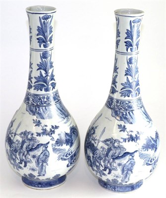 Lot 643 - A pair of Chinese blue and white bottle vases, in 17th century style, decorated underglaze blue...