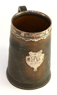 Lot 649 - A silver mounted leather mug applied with a cartouche engraved with a monogram, import marks,...