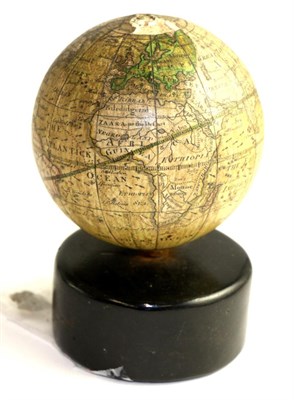 Lot 652 - A 19th century new globe of the earth, raised on an ebonised stand, 11cm high