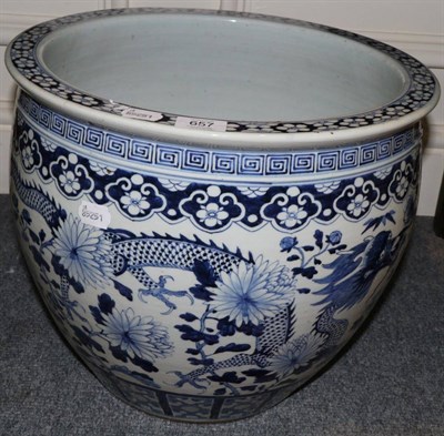 Lot 657 - A Chinese porcelain jardiniere, 19th century, painted overglaze blue dragons amongst foliage,...