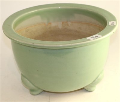 Lot 658 - A Chinese celadon ground jardiniere, on three scroll feet, 32cm diameter