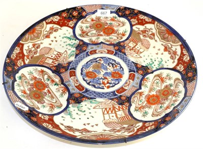 Lot 667 - A Japanese Imari porcelain charger, Meiji period (1868-1912) typically painted with a central...