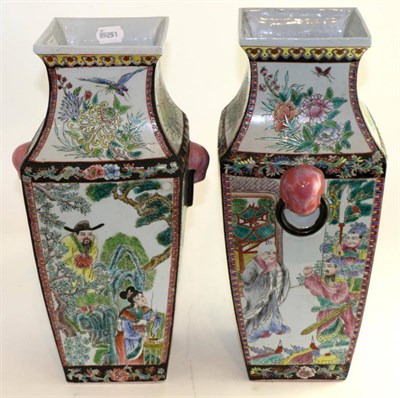 Lot 670 - A pair of Chinese square section baluster vases with mask and loop handles, decorated in...