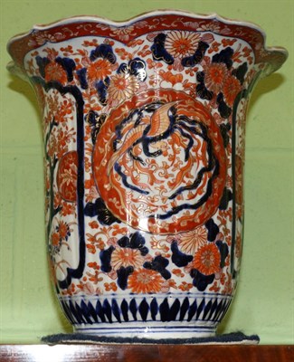 Lot 674 - An Imari porcelain vase, circa 1900, of fluted ovoid form with flared floriform rim, typically...