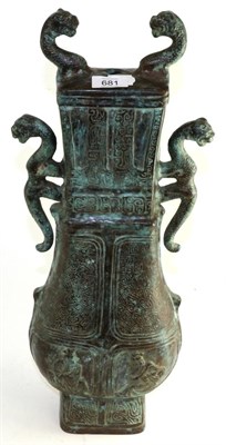 Lot 681 - A Chinese bronze vase of Archaic form, with mythical beast handles decorated with Taotie, 54cm high