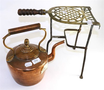 Lot 711 - A copper fireside kettle with trivet