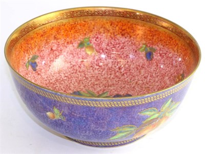 Lot 717 - A Wedgwood lustre bowl decorated with fruit, the interior red ground, the exterior blue (star...