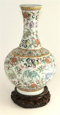 Lot 718 - A Chinese porcelain bottle vase, painted in famille rose enamels with bats and Shou characters...