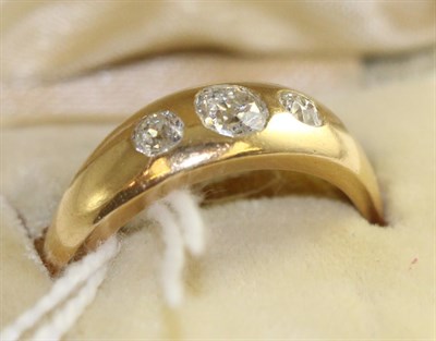 Lot 727 - A diamond three stone ring, graduated old cut diamonds drill set into a plain polished flat...