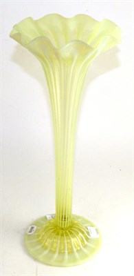 Lot 755 - A early 20th century green vaseline glass tapering vase, 47cm high