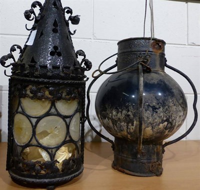 Lot 768 - A black painted metal ornamental hanging lamp, 52cm high; a metal and blue glass hanging lamp;...