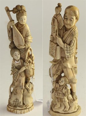 Lot 794 - A pair of Japanese ivory okimonos, Meiji period, as a family of entertainers she with a lute he...