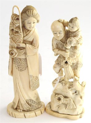 Lot 797 - A Japanese ivory okimono of a man Meiji period, with his son on his shoulders and dog at their feet