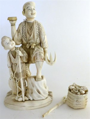 Lot 799 - A Japanese ivory okimono Meiji period as a fisherman and boy with a basket of fish, height 27cm