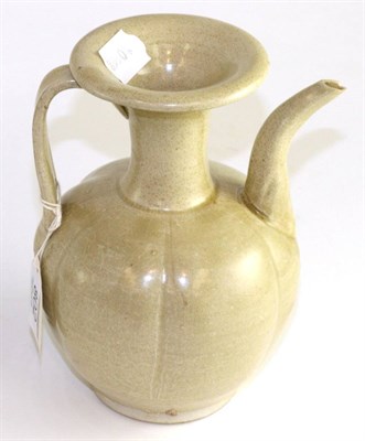 Lot 802 - A Chinese celadon glazed ewer in Song style, of fluted ovoid form with flared neck, scroll...