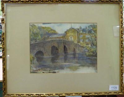 Lot 1109 - Rowland Henry Hill (1873-1952) A house beyond a bridge in a river landscape, signed and dated 1933