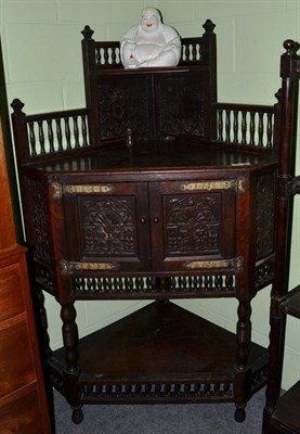 Lot 1242 - A carved oak free standing corner cupboard, 100cm wide