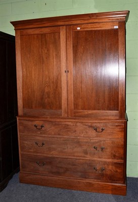 Lot 1243 - ~ A George III style mahogany and pine lined linen press with two cupboard doors over three...