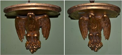 Lot 1248 - A pair of 19th century gilt wood ad gesso wall brackets in form of eagles, 30cm wide