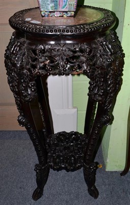 Lot 1250 - An early 20th century Chinese hardwood plant stand with pink marble top, 93cm high