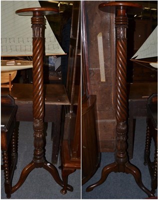 Lot 1252 - A pair of 19th century mahogany Wrythen-form torchere stands, on tripod bases, 51cm high (2)