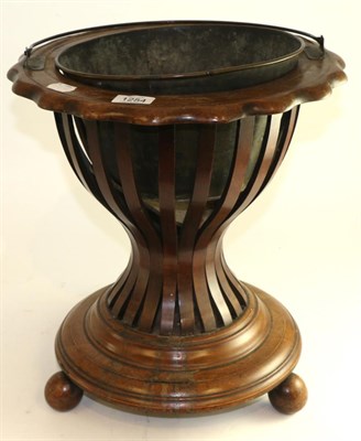 Lot 1254 - A late 19th century mahogany planter with carrying handle and slatted body, 41cm high