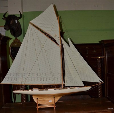 Lot 1259 - A large scale model pond yacht with linen sail and a cream painted hull, maximum width 170cm