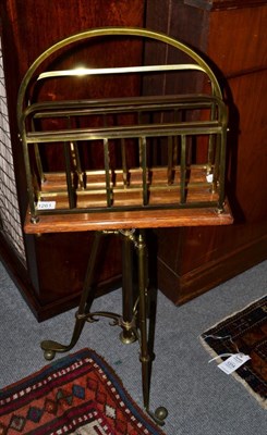 Lot 1261 - An adjustable Edwardian brass and wood magazine rack on stand, the legs in the form of golf...