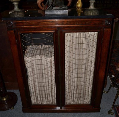 Lot 1262 - A Regency rosewood side cabinet, early 19th century, the later black marble rectangular top...