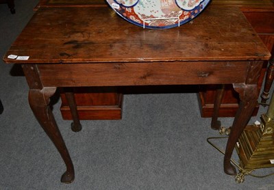 Lot 1267 - An 18th century oak side table on cabriole legs, 92cm wide