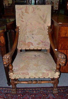 Lot 1279 - A walnut open armchair in the 17th century style with lion mask handles and claw feet, 72cm wide