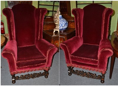 Lot 1293 - A pair of Queen Anne style wingback chairs, late 19th/early 20th century, upholstered in red...