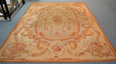 Lot 1304 - A French style needlepoint carpet, China, the central oval panel with naturalistic floral...