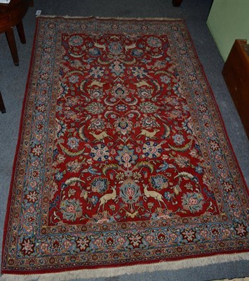 Lot 1307 - A Kasvin rug, West Iran, the crimson field of serrated leaves, animals and birds enclosed by...