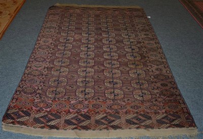 Lot 1323 - Tekke rug, Emirate of Bukhara, the aubergine field with three columns of guls enclosed by...