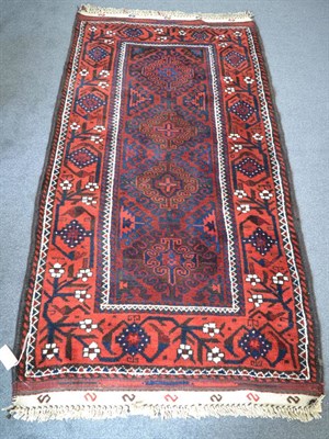 Lot 1333 - Balouch rug, Iranian/Afghan Frontier, the indigo field with a column of hooked medallions...