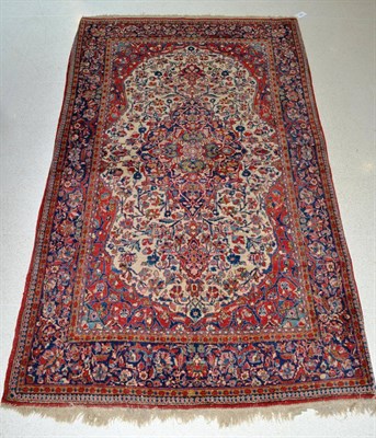 Lot 1334 - Kashan rug, Central Iran, the cream field of scrolling vines around an indigo medallion framed...