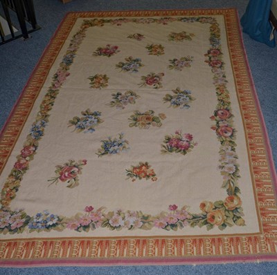 Lot 1339 - A needlepoint carpet, China, the cream field with an allover design of floral sprays enclosed...