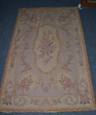 Lot 1340 - A needlepoint carpet, China, the field centred by a panel of naturalistic flowers enclosed by leafy