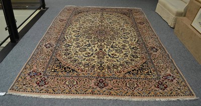 Lot 1343 - Isfahan carpet, Central Iran, the ivory field of scrolling vines and palmettes around a pole...