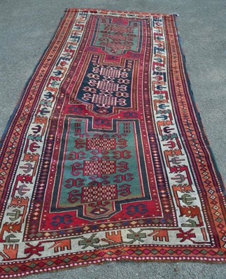 Lot 1348 - An unusual 19th century Yuruk prayer rug, East Anatolia, the raspberry field with three Mihrabs...