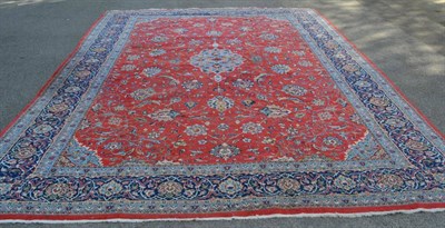 Lot 1358 - A Saroukh carpet, West Iran, the crimson field of palmettes and vines around a sky blue pole...