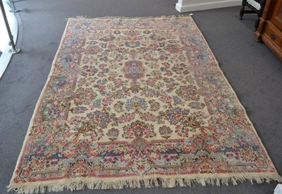 Lot 1364 - Kirman carpet, South East Iran, the cream field of semi-naturalistic sprays around a sky blue...