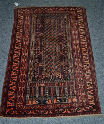 Lot 1373 - A Balouch prayer rug, West Afghanistan, the narrow indigo field beneath multiple Mihrabs...