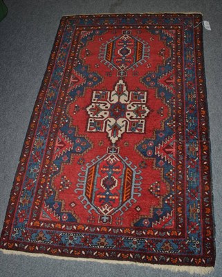 Lot 1378 - Heriz rug, Iranian Azerbaijan, the blood red field with three hooked medallions, enclosed by narrow