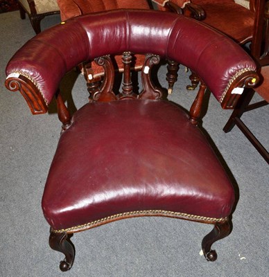 Lot 1384 - A 19th century leather and mahogany club chair, of horseshoe form, cabriole legs, formally...