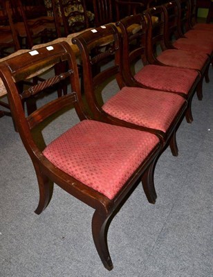 Lot 1387 - A set of seven Regency mahogany dining chairs with part writhern spindle back supports, above...