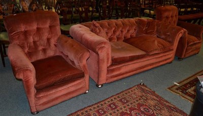 Lot 1390 - A late Victorian three-piece suite, comprising a Chesterfield sofa and a pair of armchairs...