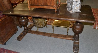 Lot 1400 - An oak refectory table raised on carved bulbous legs, joined by an H stretcher, 176cm long