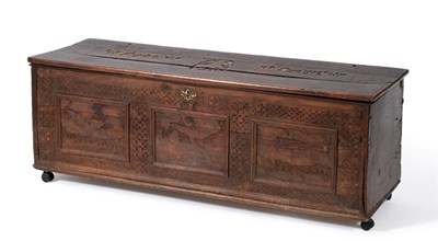 Lot 1403 - A 17th century Italian walnut cassone, with chip carved decoration, the three plank hinged lid...